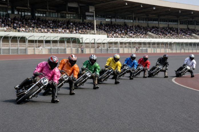 Eight riders leaning through a left turn in Japanese Auto Race