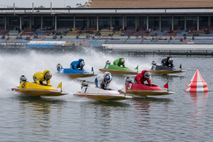 Six Japanese BOAT RACE hydroplanes turning at a racecourse